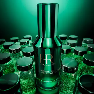 Helena Rubinstein Powercell Skinmunity [EXO] green serum bottle surrounded by lab glass jars.