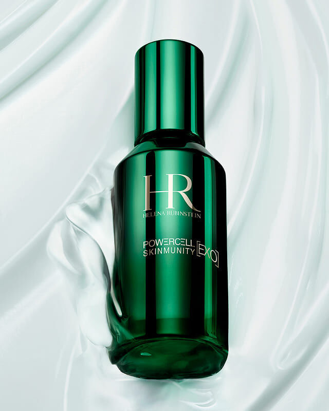 Powercell Skinmunity [EXO] Serum bottle on a silky texture, highlighting its gentle formula for sensitive skin.