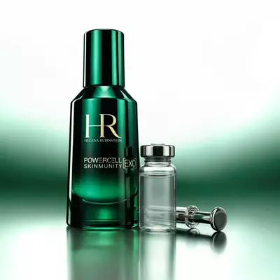 Helena Rubinstein Powercell Skinmunity  [EXO] green bottle alongside a laboratory glass ampoule and applicator.