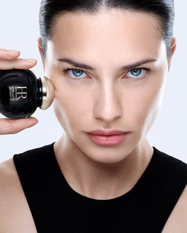 Adriana Lima applies Helena Rubinstein REPLASTY Age Recovery with its golden applicator.