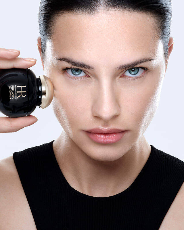 Adriana Lima applies Helena Rubinstein REPLASTY Age Recovery with its golden applicator.