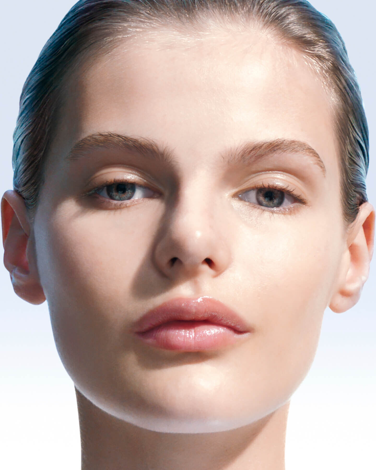 Close-up of a woman’s face with smooth, luminous skin.