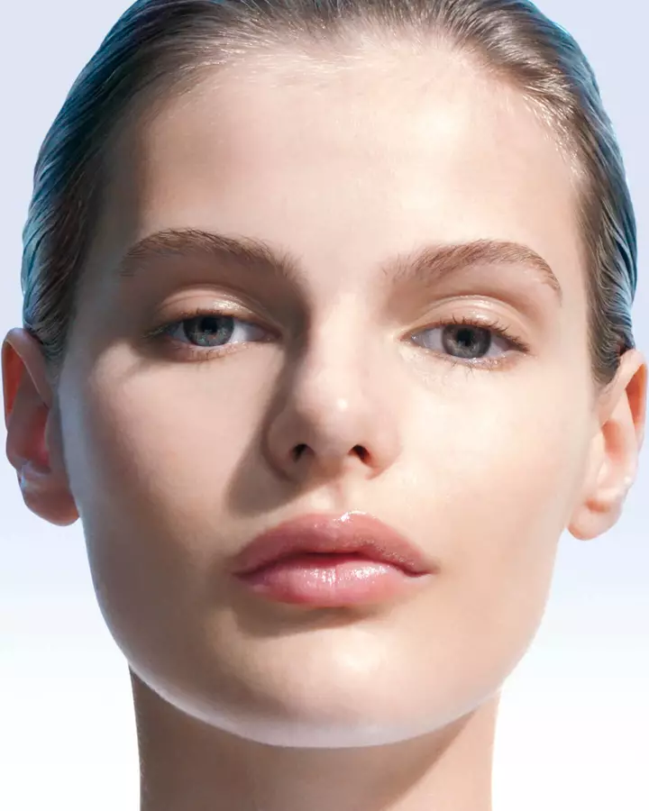 Close-up of a woman’s face with smooth, luminous skin.