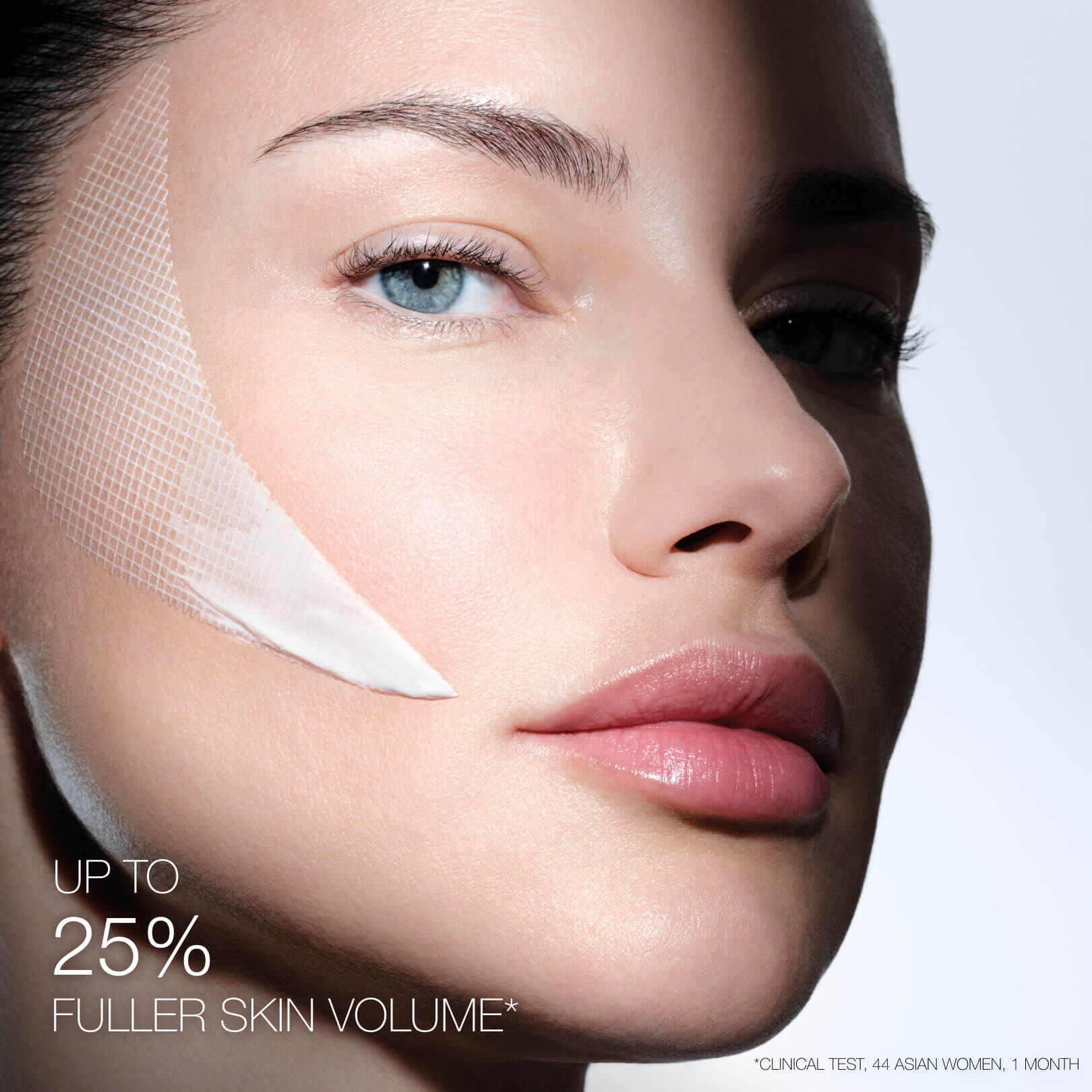 Woman's face with Helena Rubinstein REPLASTY cream and innovative bandage texture on her cheek.