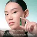 Model holding a green Powercell Skinmunity EXO ampoule next to her face.